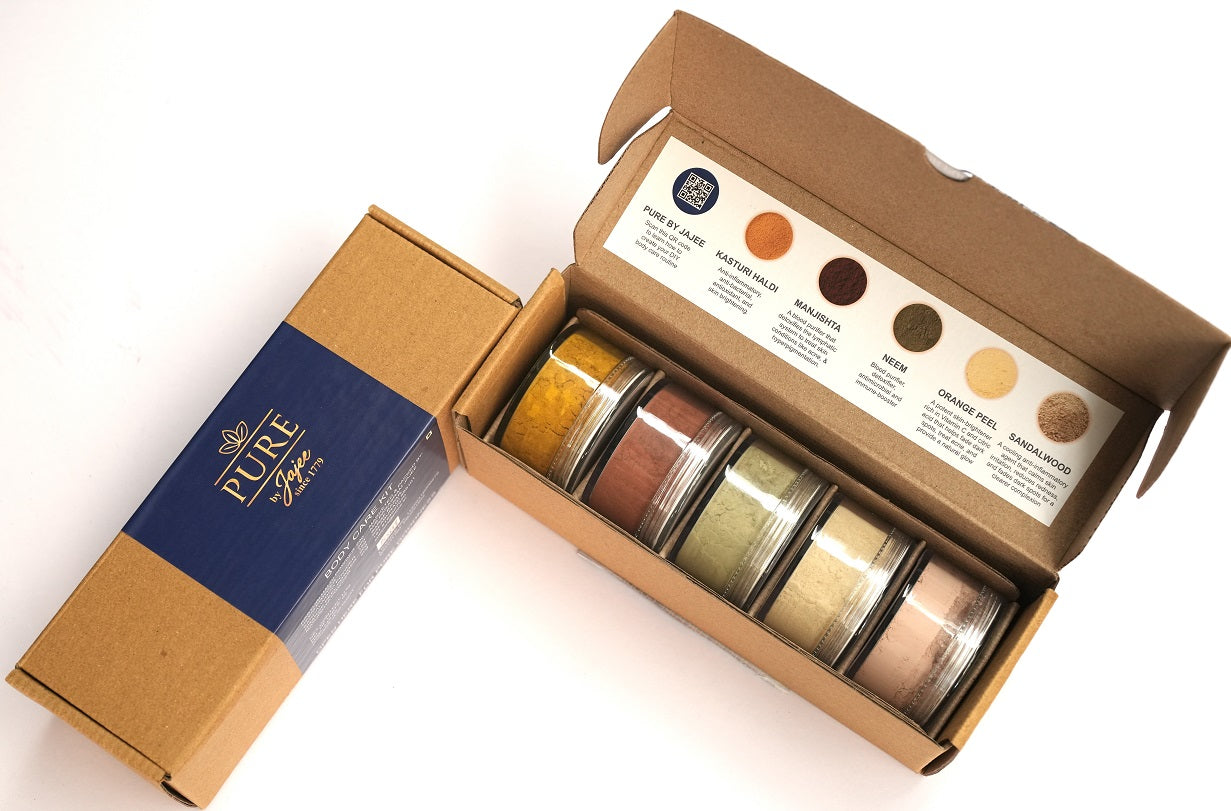 Pure by Jajee Body Care Kit featuring 5 individual jars of pure Kasturi Haldi, Neem, Sandalwood, Orange Peel, and Manjistha powders for Ayurvedic skincare.